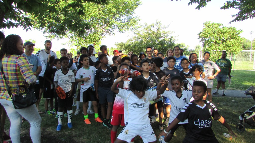 Youth players listening to coach instructions