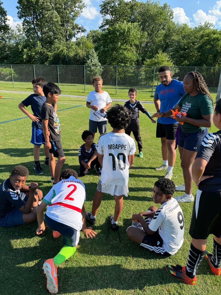 SOS mentors with youth on the field